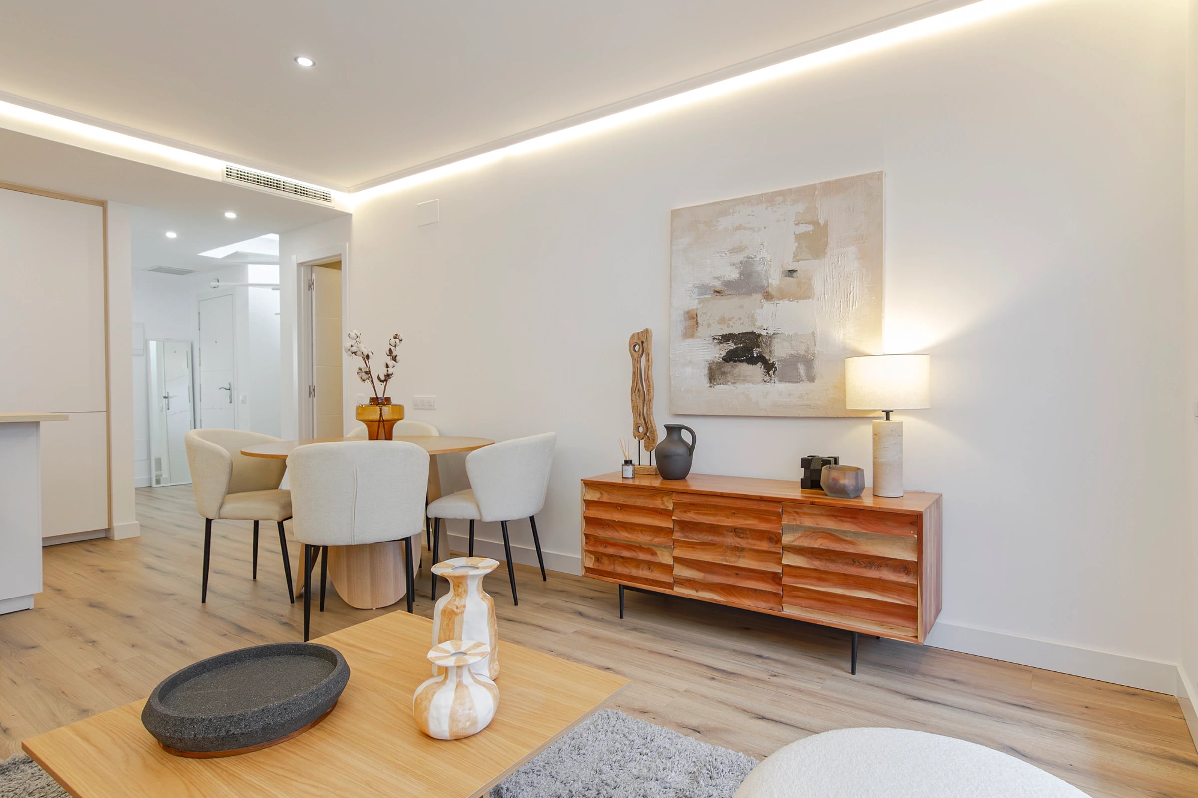 Finished residential interior with warm timber, soft lighting, and dining detail.