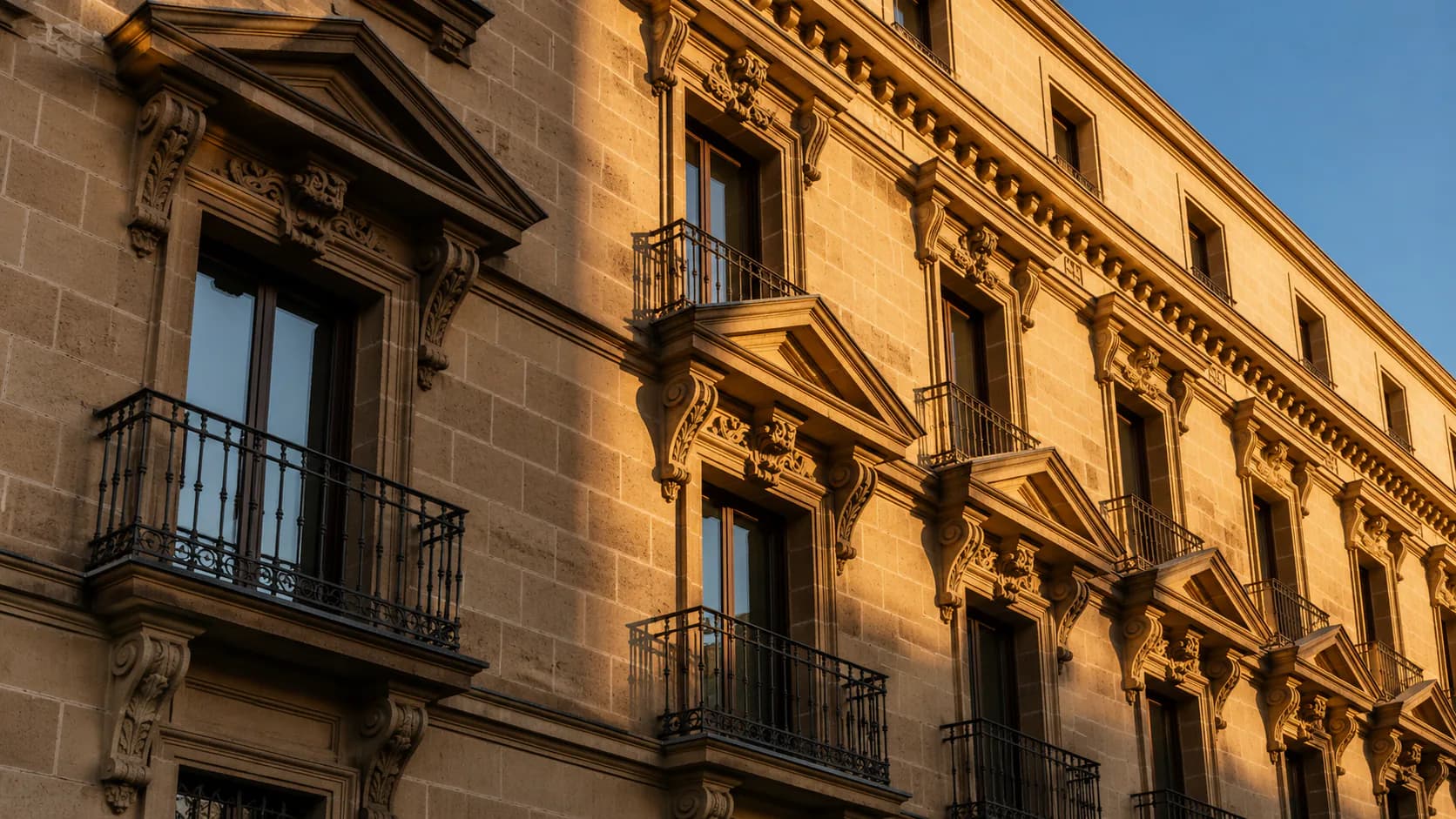 Historic stone facade illuminated by warm evening light.